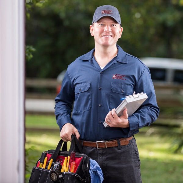 Contractor smiling with tools equipped