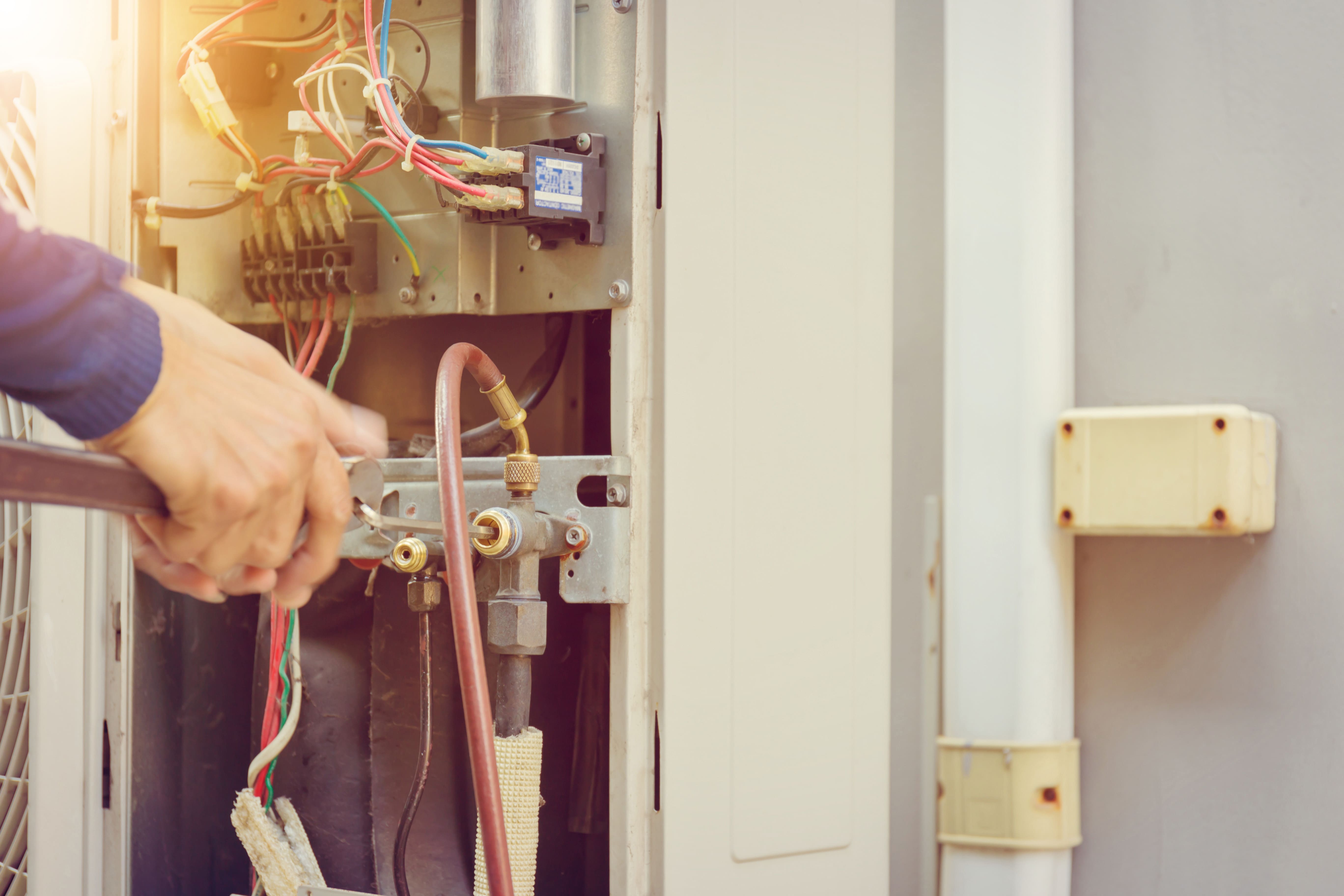 Man installing unit using tool